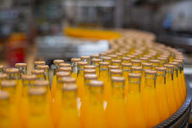 Beverage factory interior Conveyor flowing with bottles for juice