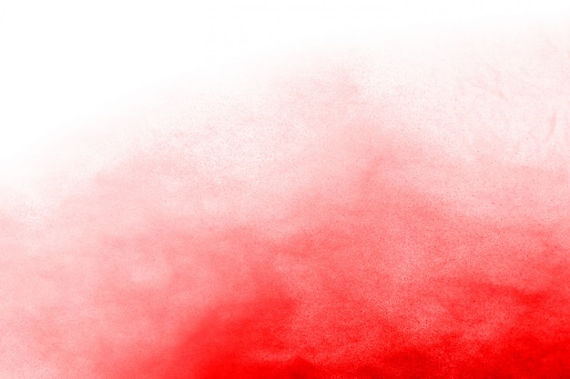 Foto bevriezen beweging van rood poeder exploderen, geïsoleerd op een witte achtergrond.