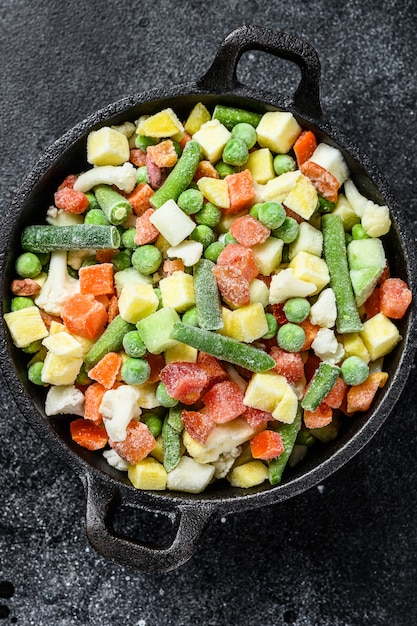 Bevroren rauwe groenten in een pan.