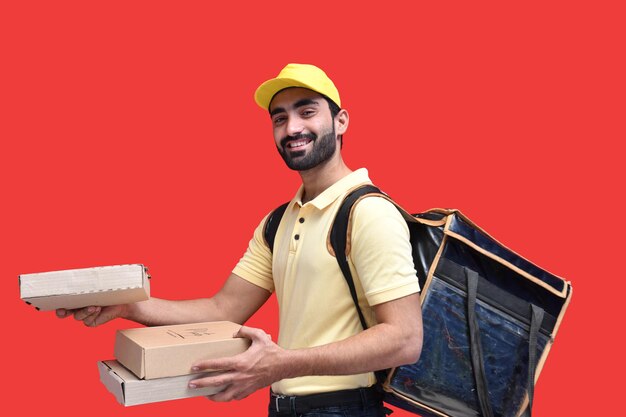 bezorger in geel t-shirt met rugzak met afhaalmaaltijden Indiaas Pakistaans model