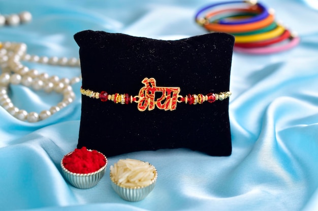 Photo bhaiya rakhi with roli chawal on blue background