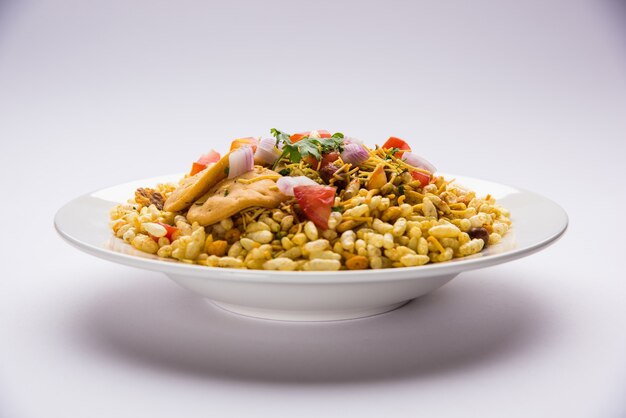 Bhel Puri is a savoury snack or Chaat item from India. It is made of puffed rice, vegetables &amp; tangy tamarind sauce. Popular Indian road side food