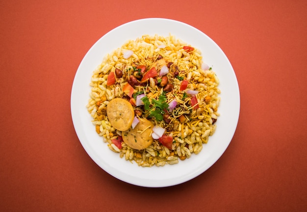 Bhel Puri is a savoury snack or Chaat item from India. It is made of puffed rice, vegetables &amp; tangy tamarind sauce. Popular Indian road side food