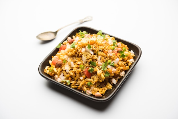 Bhelpuri Chaat or chat is a road side tasty food from India, served in a bowl or plate. selective focus