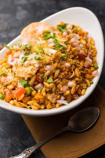 Bhelpuri Chaat or chat is a road side tasty food from India, served in a bowl or plate. selective focus