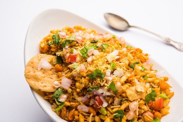 Bhelpuri Chaat or chat is a road side tasty food from India, served in a bowl or plate. selective focus