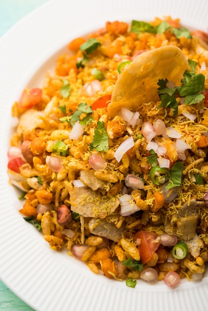 Bhelpuri Chaat or chat is a road side tasty food from India, served in a bowl or plate. selective focus