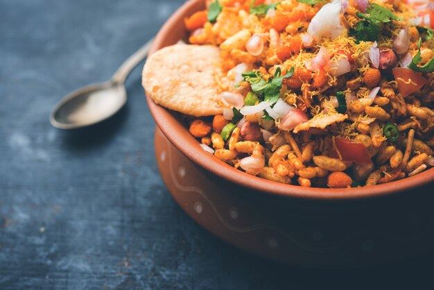 Bhelpuri Chaat or chat is a road side tasty food from India, served in a bowl or plate. selective focus