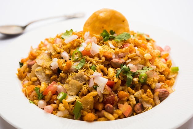 Bhelpuri Chaat or chat is a road side tasty food from India, served in a bowl or plate. selective focus