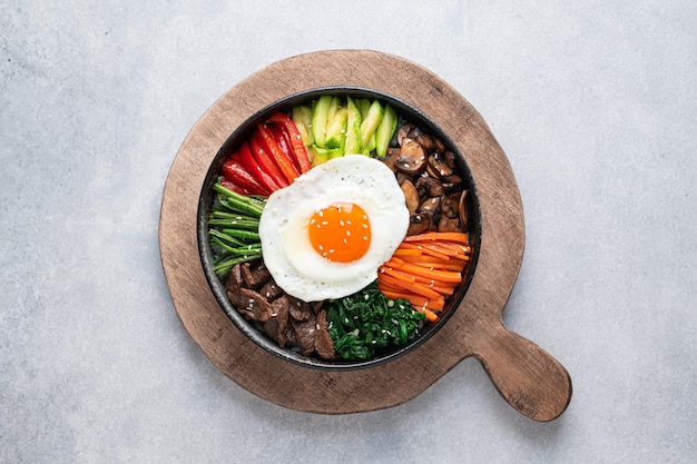 Bibimbap on a concrete background traditional korean dish top view