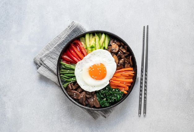 Bibimbap on a concrete background traditional korean dish top view