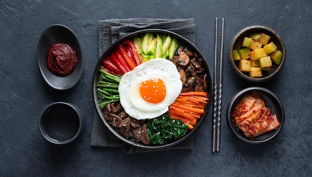 Bibimbap on a dark concrete background traditional korean dish top view