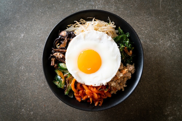 Bibimbap, insalata piccante coreana con riso e uovo fritto - stile alimentare tradizionalmente coreano