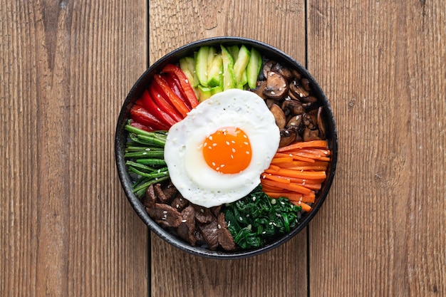 Bibimbap on a wooden background traditional korean dish top view