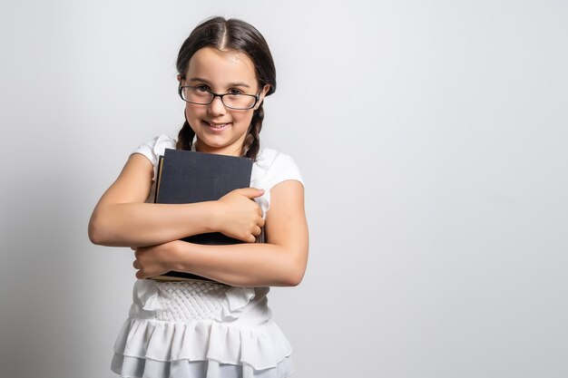 Bible, Child, Christianity. little girl holding a bible.