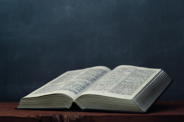 Bible and the crucifix on a Gold table Beautiful red wooden backgroundReligion concept