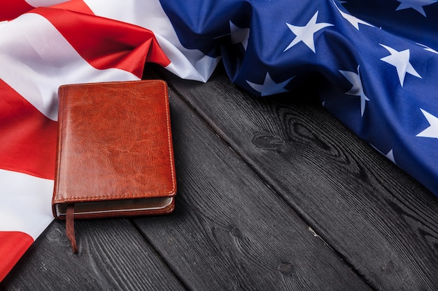 Bible laying on top of an american flag