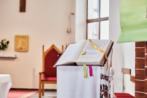 The Bible lies on a stand during the wedding in a Catholic church