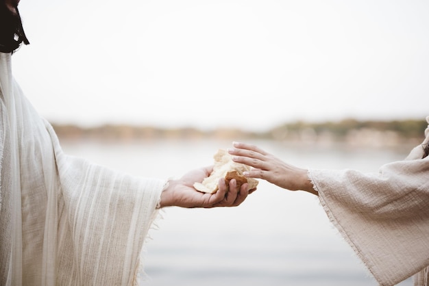 Photo biblical scene - of jesus christ giving bread to a female with a blurred background