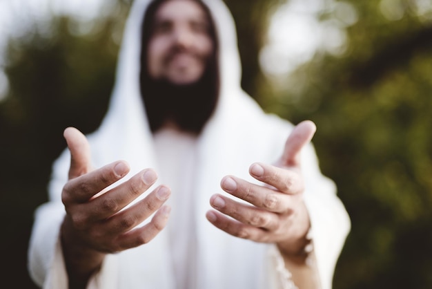 Biblical scene - of Jesus Christ landing his hands with a blurred background