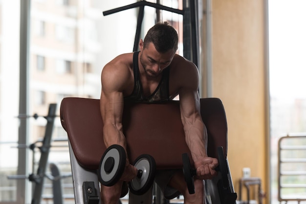 Biceps Exercise With Dumbbells In A Gym