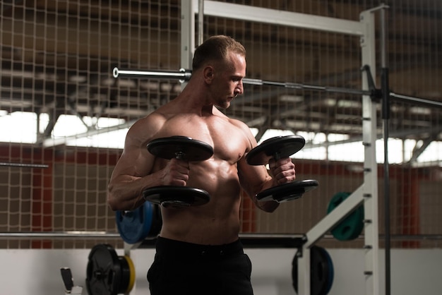 Biceps Exercise With Dumbbells In A Gym