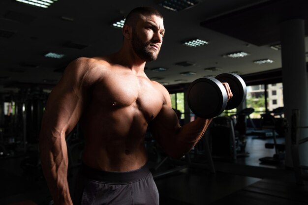 Biceps Exercise With Dumbbells In A Gym