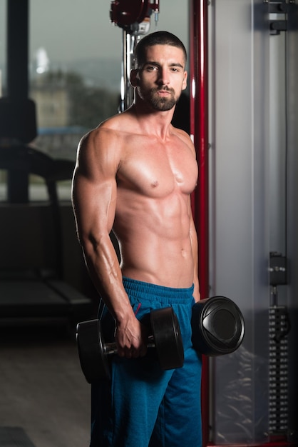 Biceps Exercise With Dumbbells In A Gym