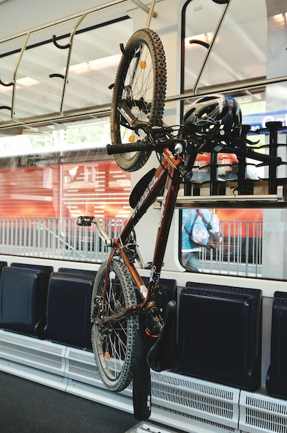 Photo bicycle hanging on hook in workshop