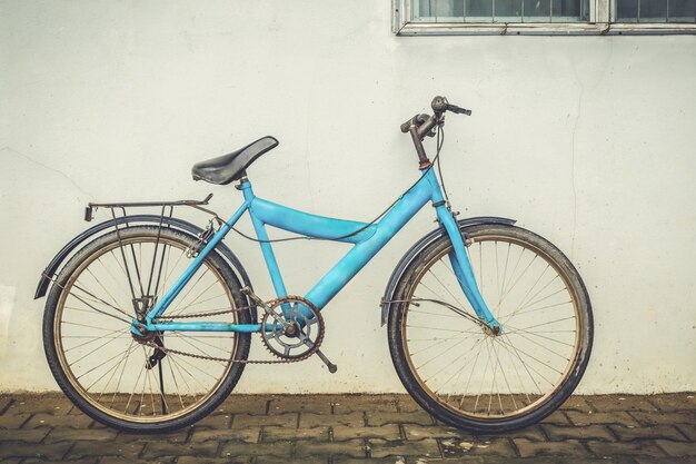 bicycle leaning against an old plaster wall home