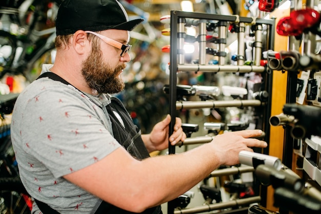 Bicycle mechanic with notebook in bike shop