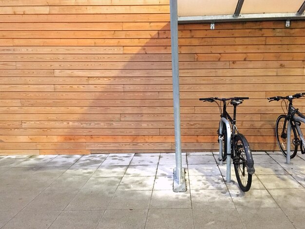 Bicycle parked against brick wall