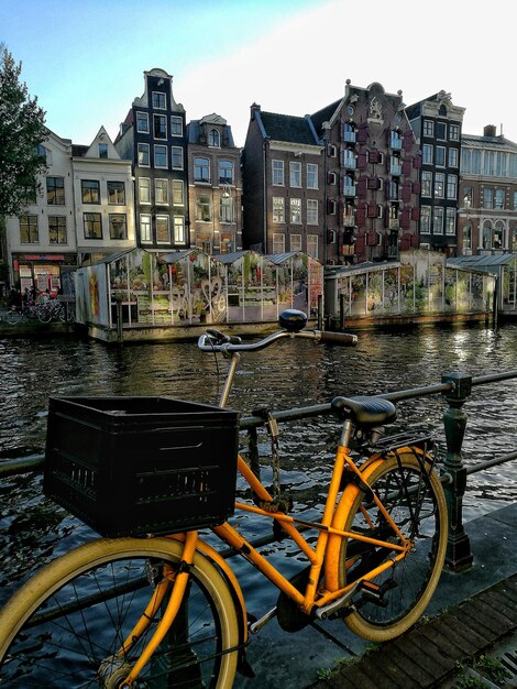 Foto bicicletta parcheggiata vicino al canale in città