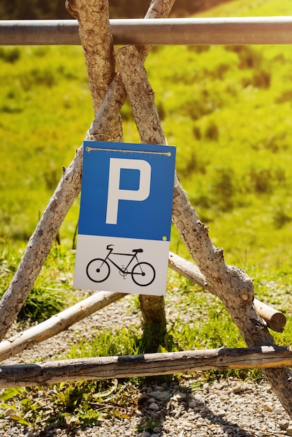 Bicycle parking sign mounted on wooden poles.