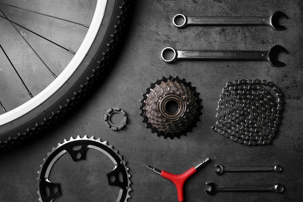 Photo bicycle parts and repair tools on gray background