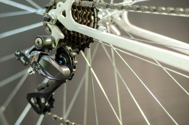 Bicycle repair Professional workshop Installing a modern rear derailleur on a vintage road bike frame The frame bike is white color