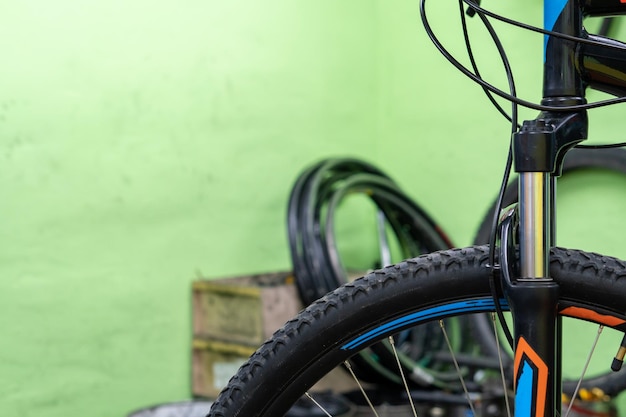 Bicycle repair shop A view of a bicycle in the workshop against the background of the working environment dirty walls a mess in the workshop poor working conditions