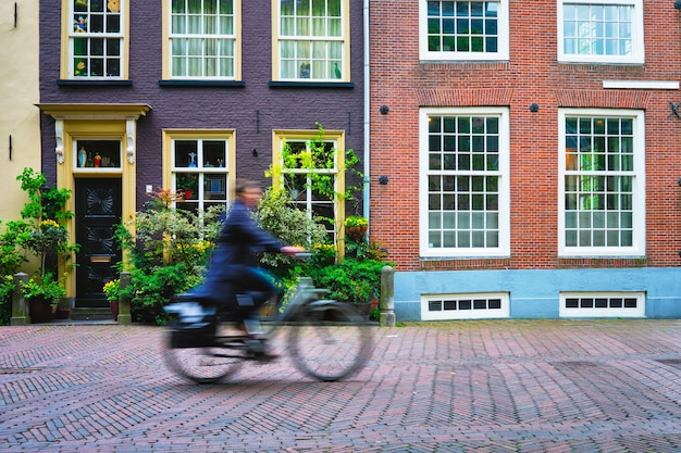 Bicycle rider cyclist man on bicycle very popular means of transoirt in netherlands in street of del...