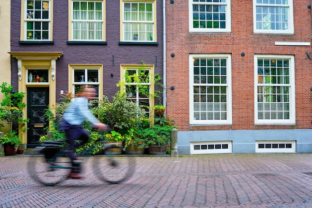 Bicycle rider cyclist man on bicycle very popular means of transoirt in netherlands in street of del...