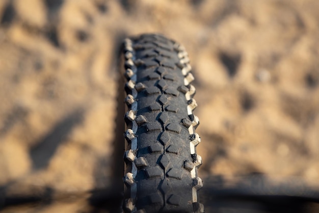 Bicycle wheel in the sand rest on the beach in the summer