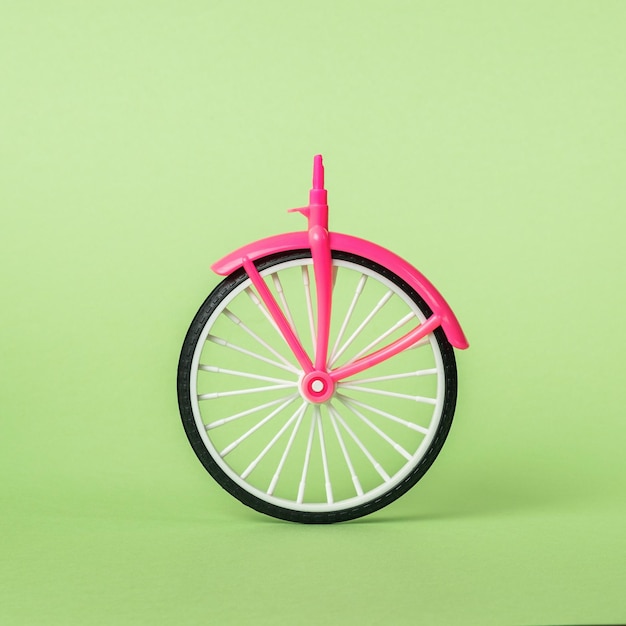 Photo a bicycle wheel with a front part on a light green background