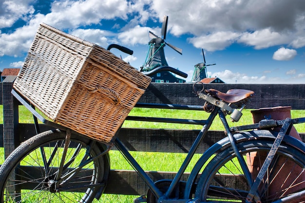 Bicycle with windmill and blue sky background Scenic countryside landscape close to Amsterdam in the Netherlands