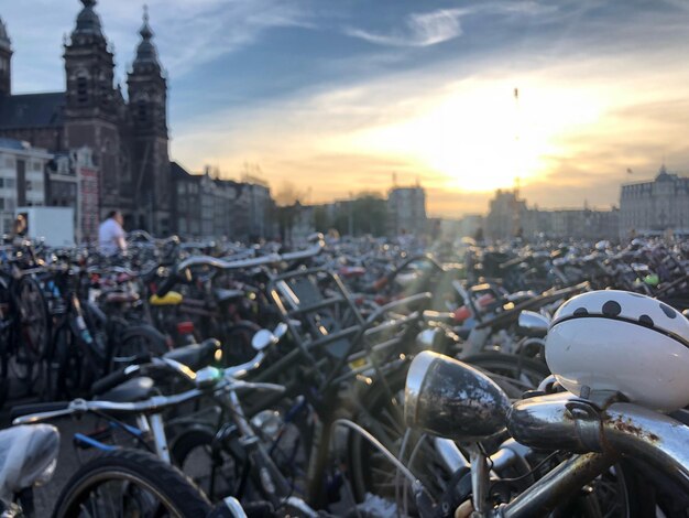 Bicycles in parking lot at city during sunset