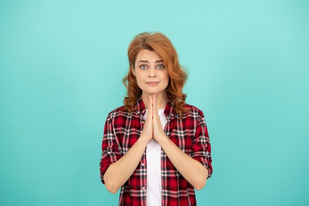 Biddende roodharige vrouw in geruit overhemd. emoties uiten. hopende dame met krullend haar. mode en schoonheid. vrouwelijke model casual trend. portret look van jong meisje. roodharige vrouw.