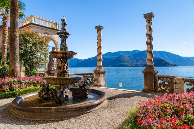 a big and artistic fountain in the garden and the mooring in a villa on lake como lombardia italy