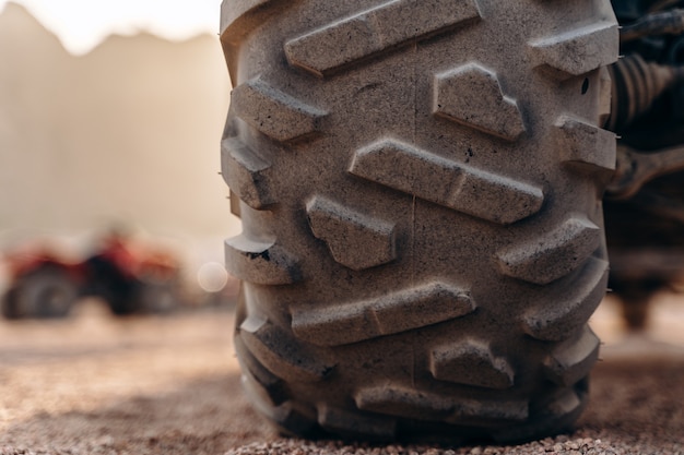 Big ATV wheel up close in the desert