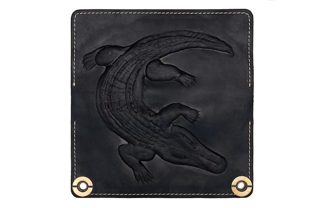 Big black leather wallet on a button on a white background crocodile print Top view