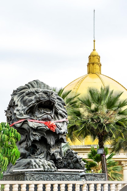 Big black lion statue front of building