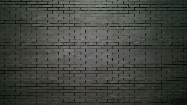 big black wall made of bricks. Black bricks texture