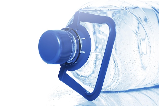 Big blue bottle of cold mineral water on white background